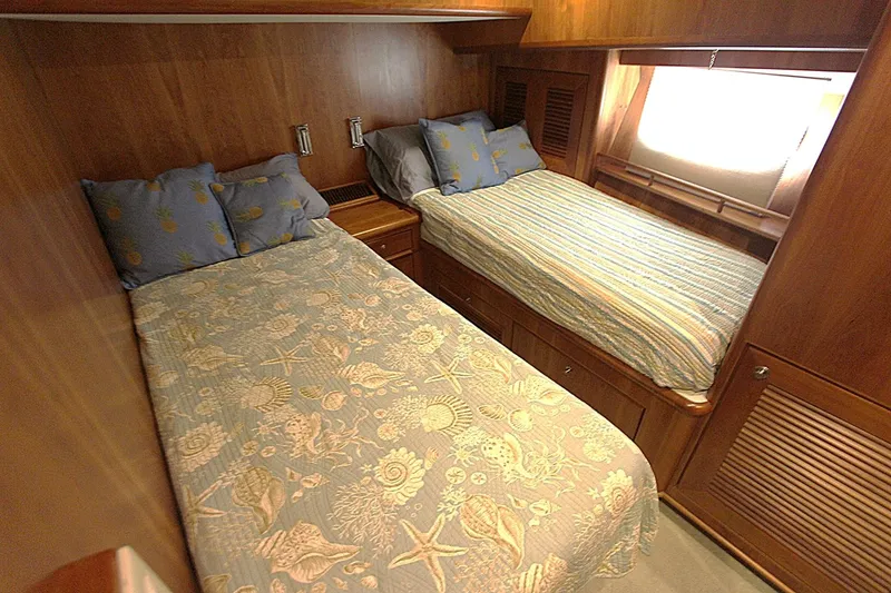 Slide: The Image of Twin beds in a cozy wooden cabin of a 2001 Symbol 62 Pilothouse yacht. - 18