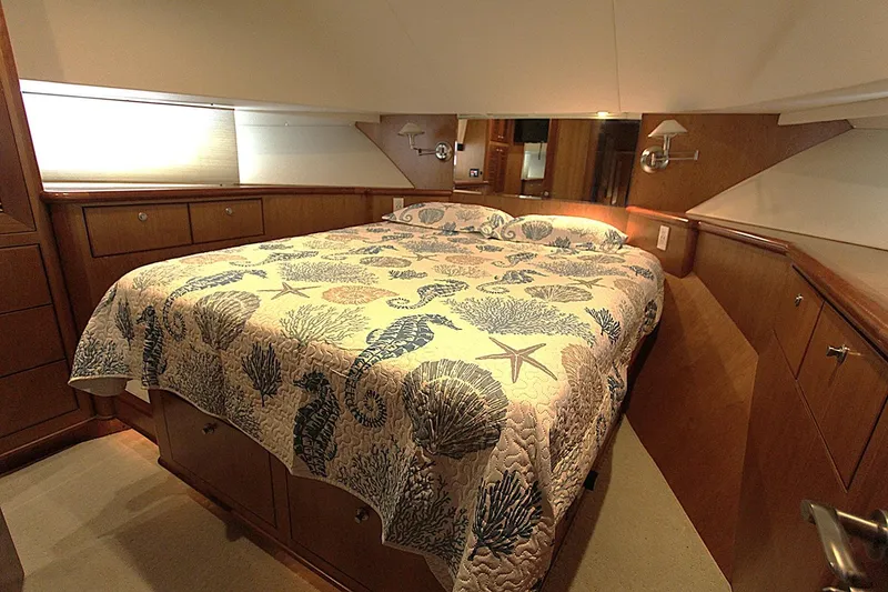 Slide: The Image of Luxurious bedroom in 2001 Symbol 62 Pilothouse yacht with nautical-themed bedding. - 19