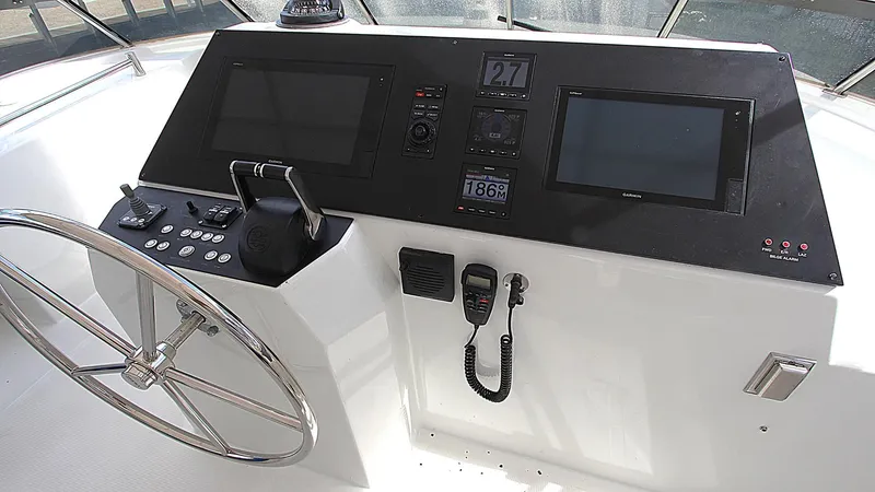 Slide: The Image of Pilothouse helm of 2001 Symbol 62, featuring steering wheel and navigation displays. - 22