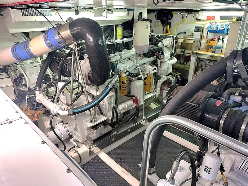 Slide: The Image of Engine room of a 2001 Symbol 62 Pilothouse yacht, showcasing mechanical components and systems. - 26