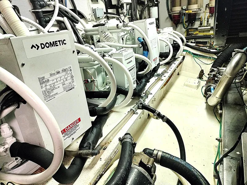 Slide: The Image of Engine room of a 2001 Symbol 62 Pilothouse with Dometic equipment and piping. - 27