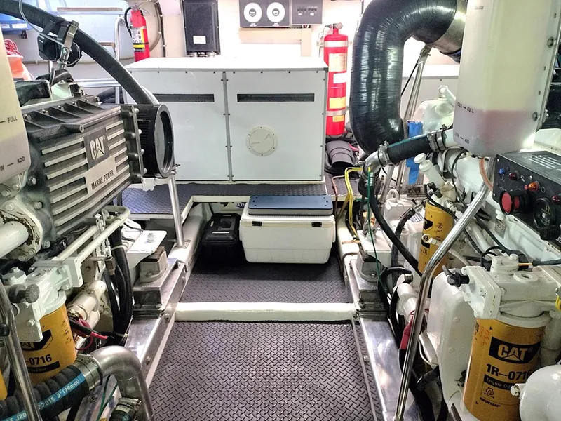 Slide: The Image of Engine room of a 2001 Symbol 62 Pilothouse yacht, featuring CAT marine engines. - 29