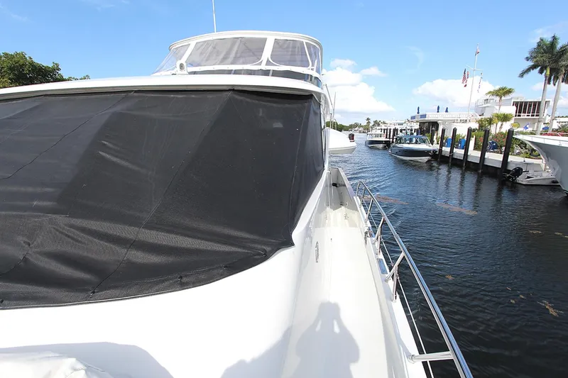Slide: The Image of 2001 Symbol 62 Pilothouse yacht docked at marina, sunny day, clear blue sky. - 6