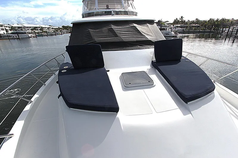 Slide: The Image of 2001 Symbol 62 Pilothouse yacht with sun loungers on deck, docked in a marina. - 7