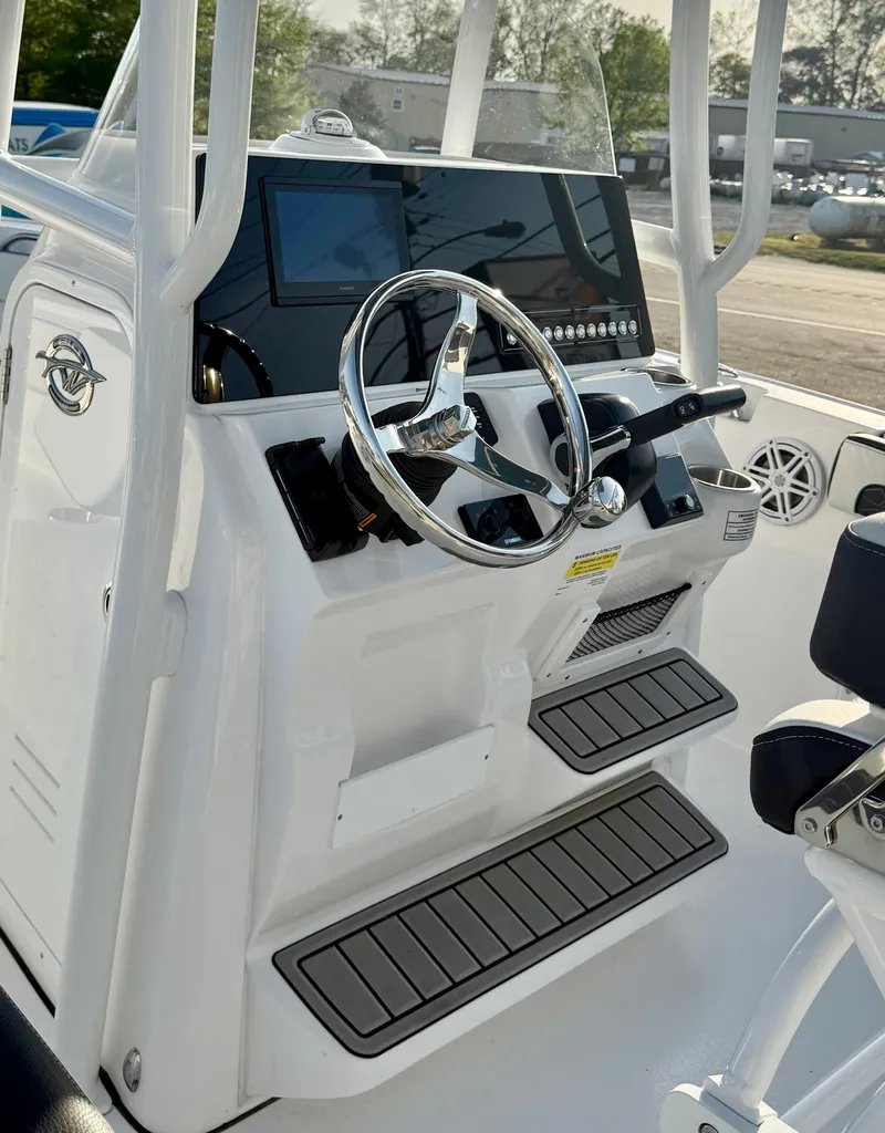 Slide: The Image of 2025 Tidewater 210 LXF boat console with steering wheel and modern controls. - 13