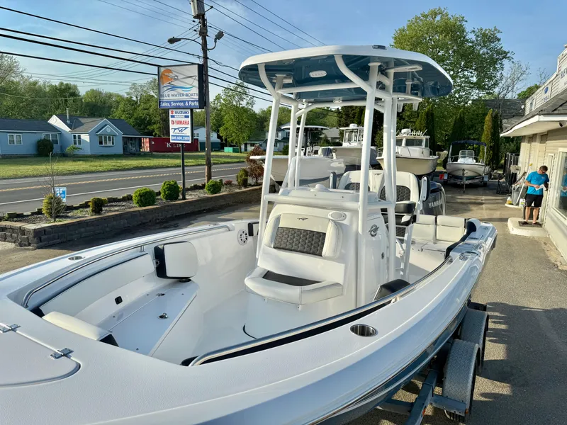 Slide: The Image of 2025 Tidewater 210 LXF boat on trailer, parked outdoors near a road. - 15