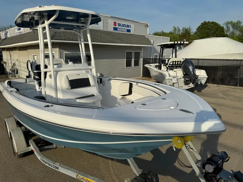 Slide: The Image of 2025 Tidewater 210 LXF boat on trailer, parked near Suzuki Marine building. - 16