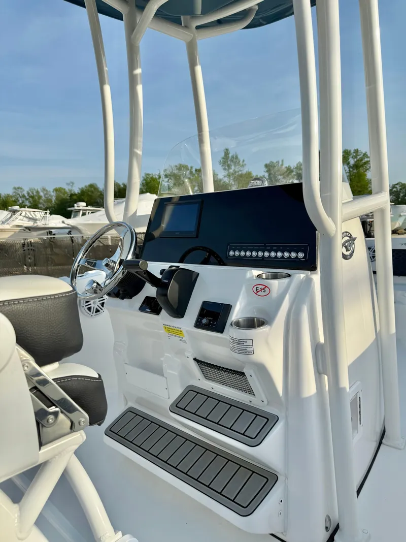 Slide: The Image of 2025 Tidewater 210 LXF boat console with steering wheel and controls. - 19
