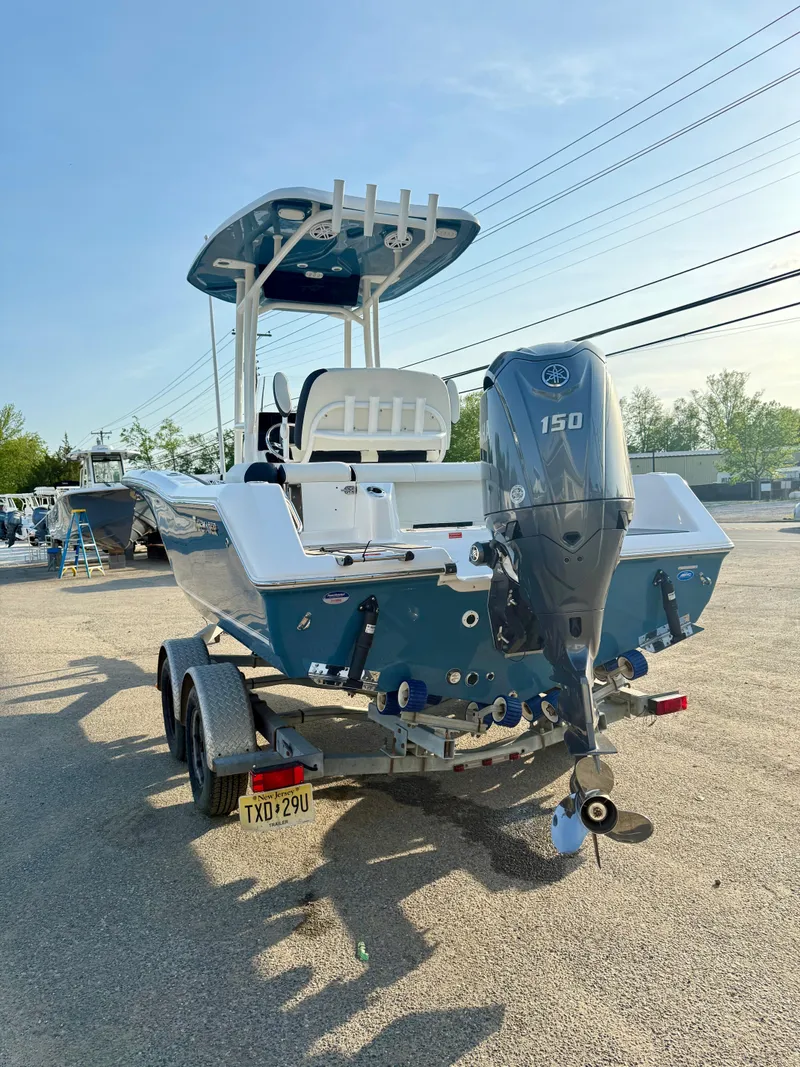 Slide: The Image of 2025 Tidewater 210 LXF boat on trailer with Yamaha 150 engine, parked outdoors. - 4