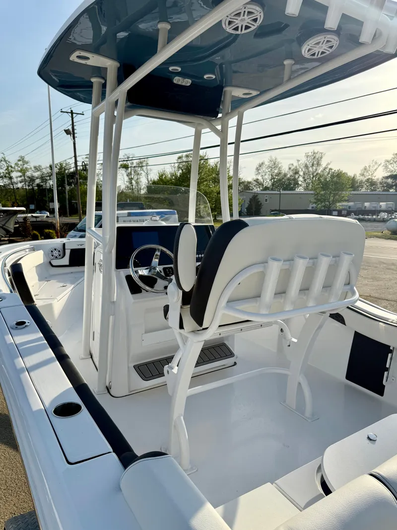Slide: The Image of 2025 Tidewater 210 LXF boat with sleek design and modern features, docked outdoors. - 8