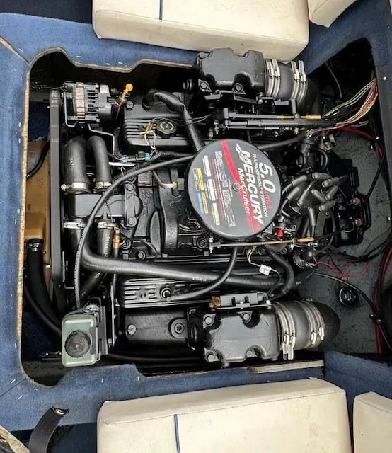 Slide: The Image of 2002 Bayliner 2150 boat engine, featuring a 5.0L Mercury motor, surrounded by seating. - 6