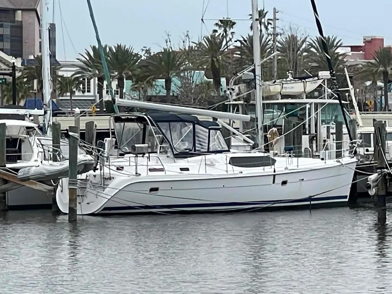 Slide: The Image of 2006 Hunter 45 Center Cockpit sailboat docked at a marina. - 11