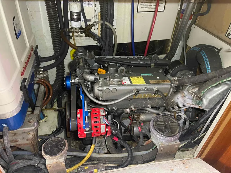 Slide: The Image of Engine compartment of a 2006 Hunter 45 Center Cockpit sailboat, showing detailed machinery and components. - 13