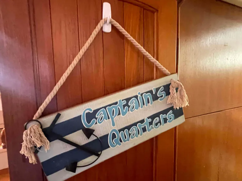 Slide: The Image of "Captain's Quarters" sign on 2006 Hunter 45 Center Cockpit boat interior door. - 17