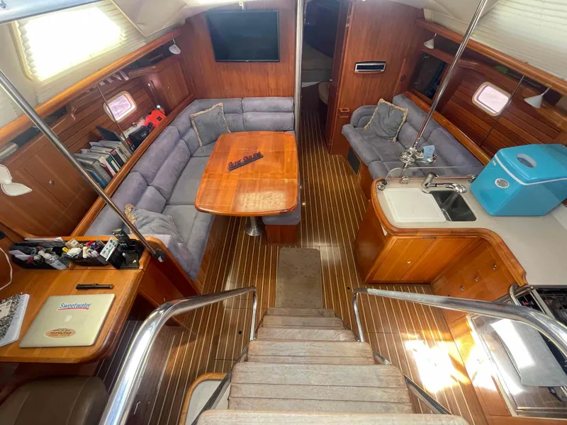 Slide: The Image of Interior of 2006 Hunter 45 Center Cockpit yacht with wood finish and cozy seating area. - 2