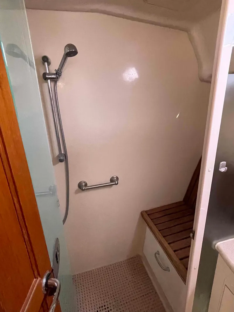 Slide: The Image of Shower area in 2006 Hunter 45 Center Cockpit yacht with wooden seat and handheld showerhead. - 22