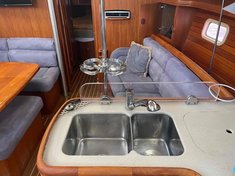 Slide: The Image of Interior of 2006 Hunter 45 Center Cockpit yacht with kitchen sink and seating area. - 30