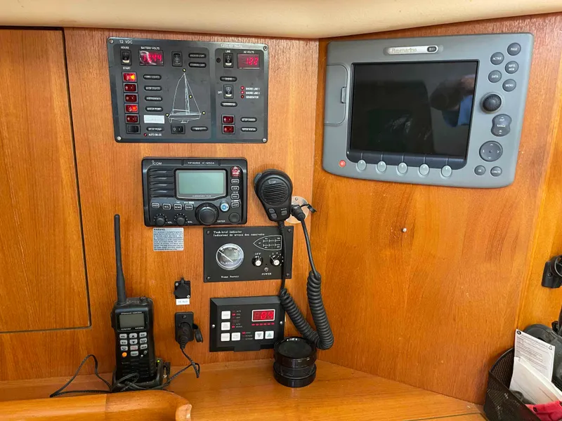 Slide: The Image of Control panel of a 2006 Hunter 45 Center Cockpit sailboat with navigation and communication equipment. - 32