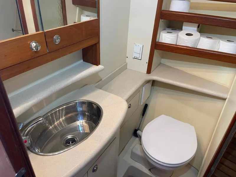 Slide: The Image of Bathroom interior of 2006 Hunter 45 Center Cockpit yacht with sink, toilet, and shelves. - 36