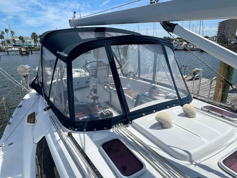 Slide: The Image of 2006 Hunter 45 Center Cockpit sailboat with covered cockpit, docked at marina. - 46