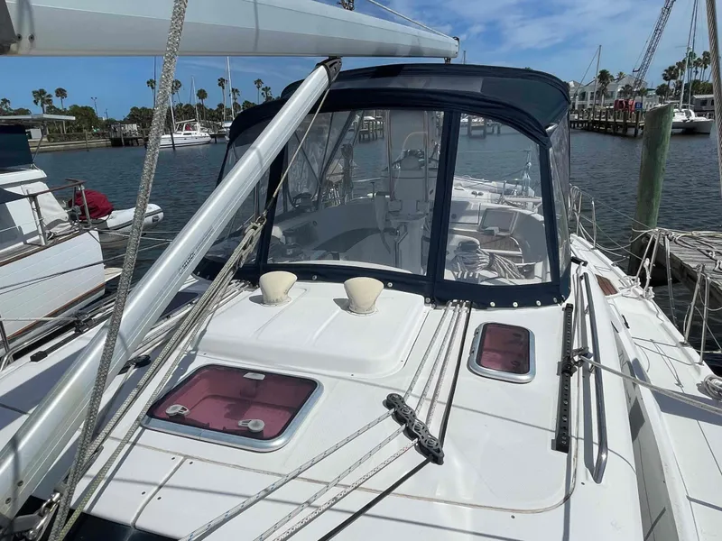Slide: The Image of 2006 Hunter 45 Center Cockpit sailboat docked, featuring a spacious cockpit and clear blue skies. - 47