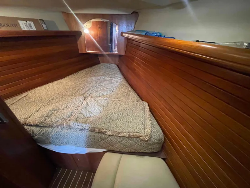Slide: The Image of Cozy cabin interior of 2006 Hunter 45 Center Cockpit sailboat with wooden paneling and bed. - 5