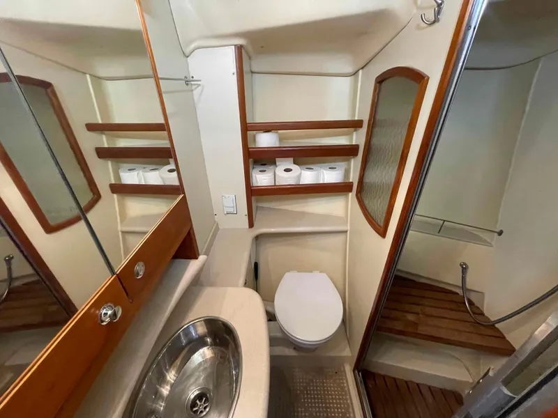 Slide: The Image of Bathroom interior of 2006 Hunter 45 Center Cockpit yacht with sink, toilet, and wooden shelves. - 6