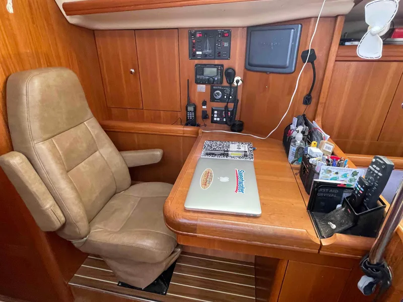 Slide: The Image of Navigation station in 2006 Hunter 45 Center Cockpit yacht with control panel and desk. - 7