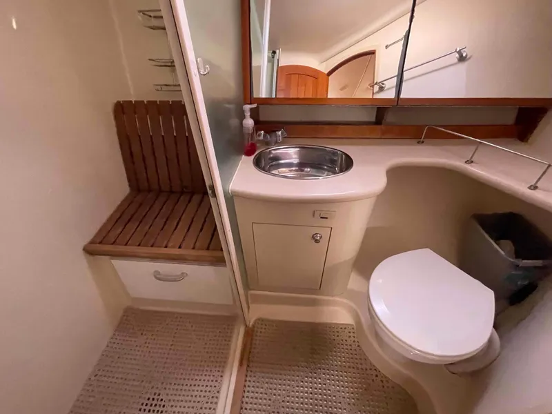 Slide: The Image of Bathroom interior of 2006 Hunter 45 Center Cockpit yacht, featuring sink, toilet, and wooden bench. - 9