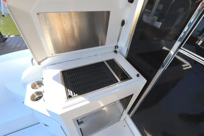 Slide: The Image of Outdoor grill on 2015 Cruisers Cantius yacht, featuring stainless steel and storage. - 10