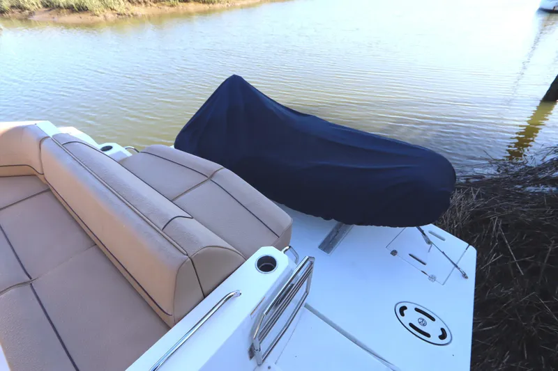 Slide: The Image of 2015 Cruisers Cantius boat with covered seating area by the water. - 15