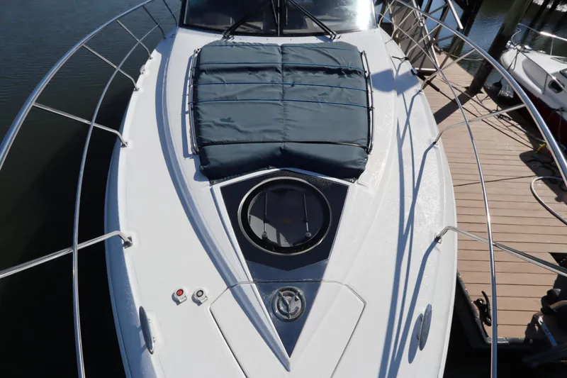 Slide: The Image of 2015 Cruisers Cantius yacht with sunpad, docked at marina. - 21
