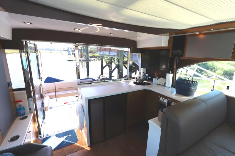 Slide: The Image of Interior of 2015 Cruisers Cantius yacht with modern kitchen and open deck view. - 35