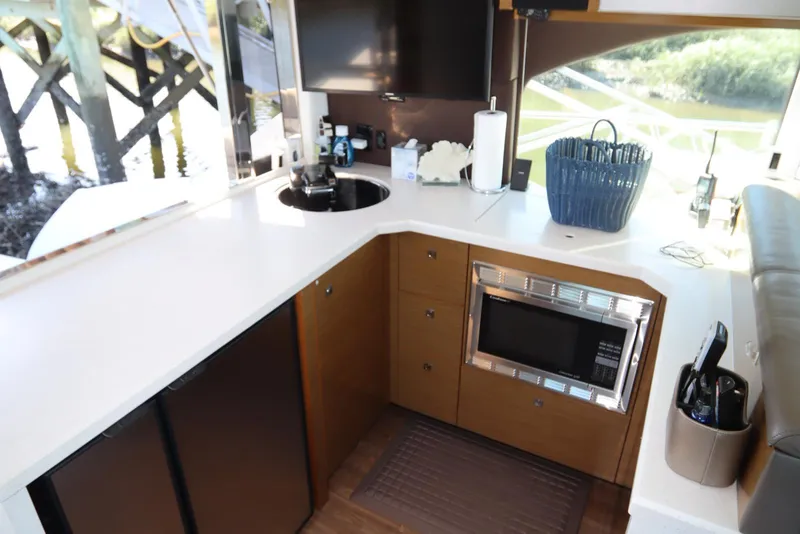 Slide: The Image of 2015 Cruisers Cantius yacht kitchen with modern appliances and sleek design. - 36