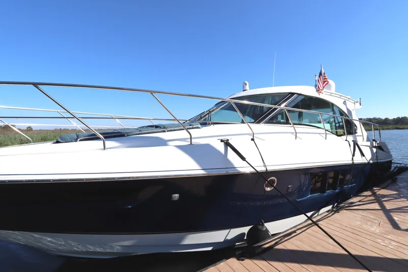 Slide: The Image of 2015 Cruisers Cantius yacht docked under clear blue sky. - 4