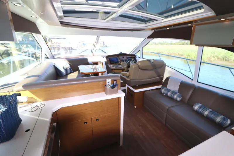 Slide: The Image of Luxurious 2015 Cruisers Cantius yacht interior with plush seating and panoramic windows. - 42