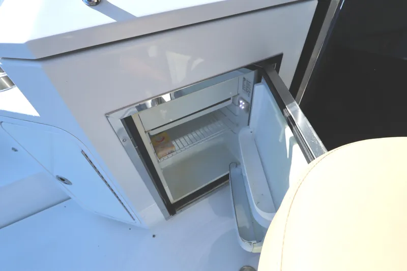 Slide: The Image of 2015 Cruisers Cantius yacht with an open mini fridge on deck. - 11