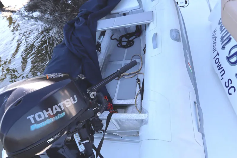 Slide: The Image of 2015 Cruisers Cantius boat with Tohatsu outboard motor, docked near water. - 19