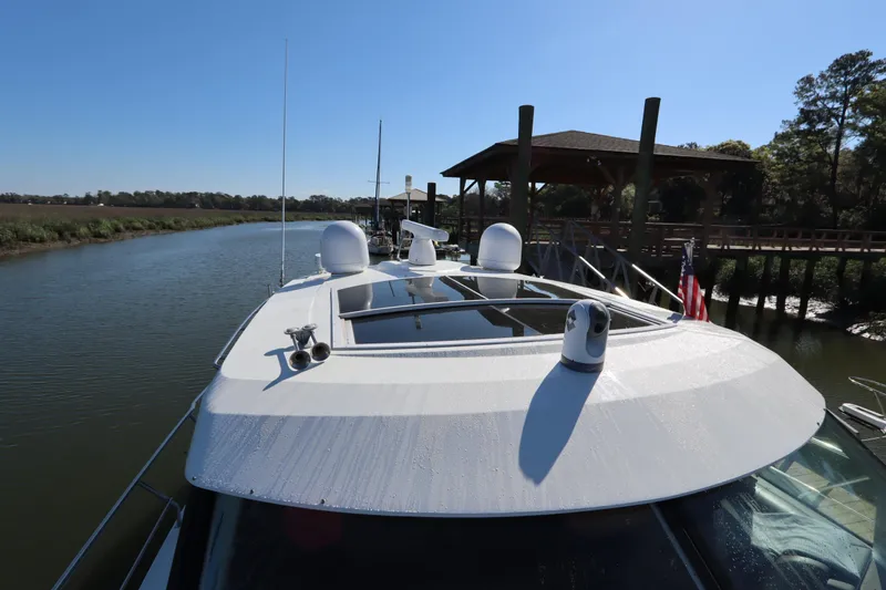 Slide: The Image of 2015 Cruisers Cantius yacht docked on a sunny day, showcasing sleek design and modern features. - 25