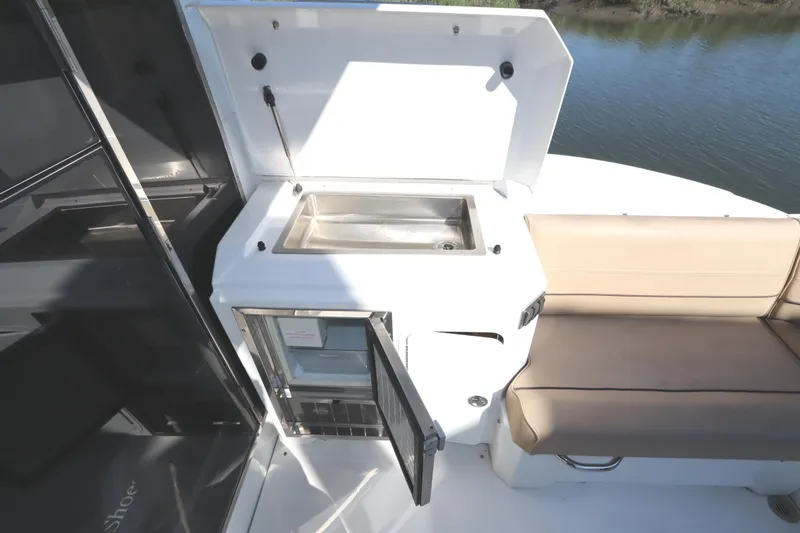 Slide: The Image of 2015 Cruisers Cantius yacht with outdoor kitchenette and seating area. - 30