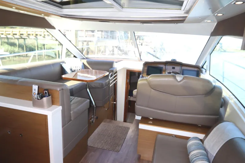 Slide: The Image of 2015 Cruisers Cantius yacht interior with modern seating and dining area. - 39