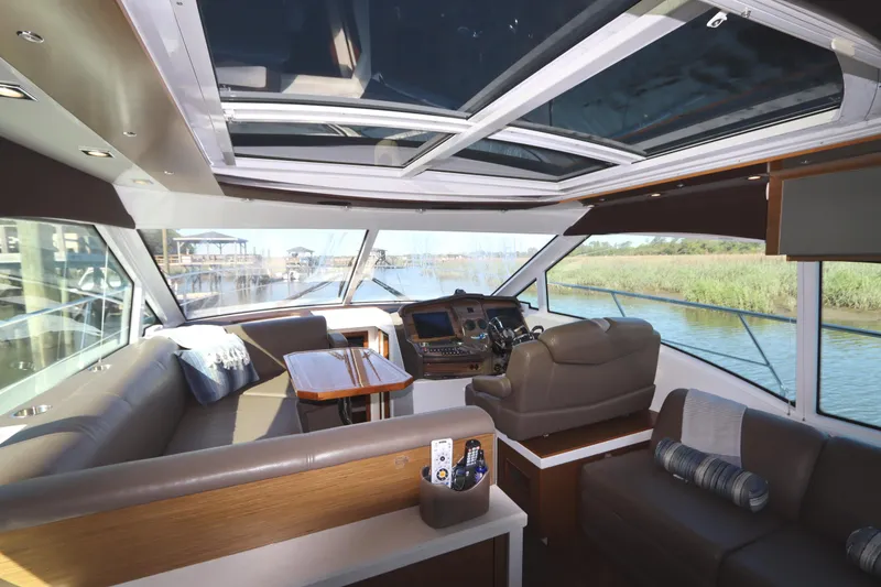 Slide: The Image of Interior of a 2015 Cruisers Cantius yacht with luxurious seating and panoramic windows. - 40