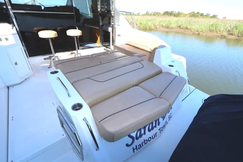 Slide: The Image of 2015 Cruisers Cantius boat with spacious rear seating and scenic water view. - 6