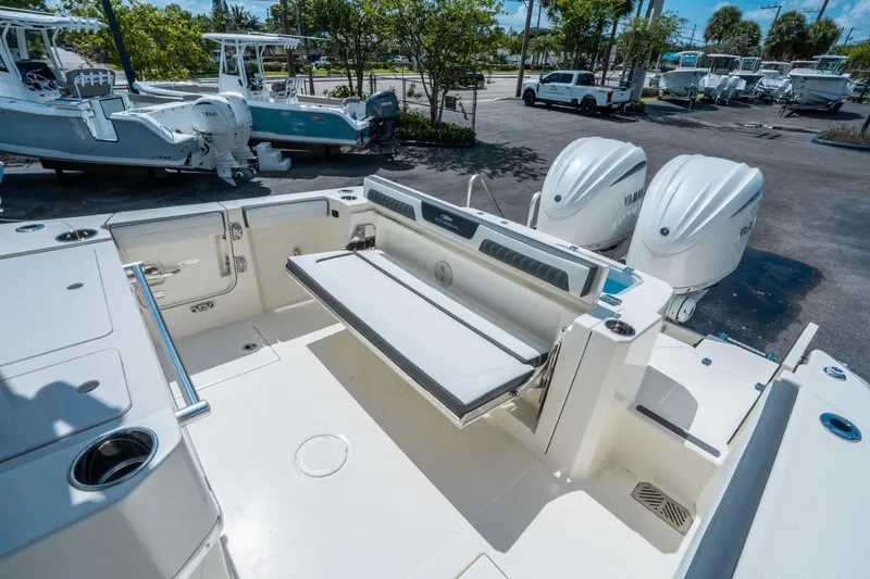 Slide: The Image of 2025 Cobia 285 CC boat with dual Yamaha engines, featuring spacious deck and seating. - 13