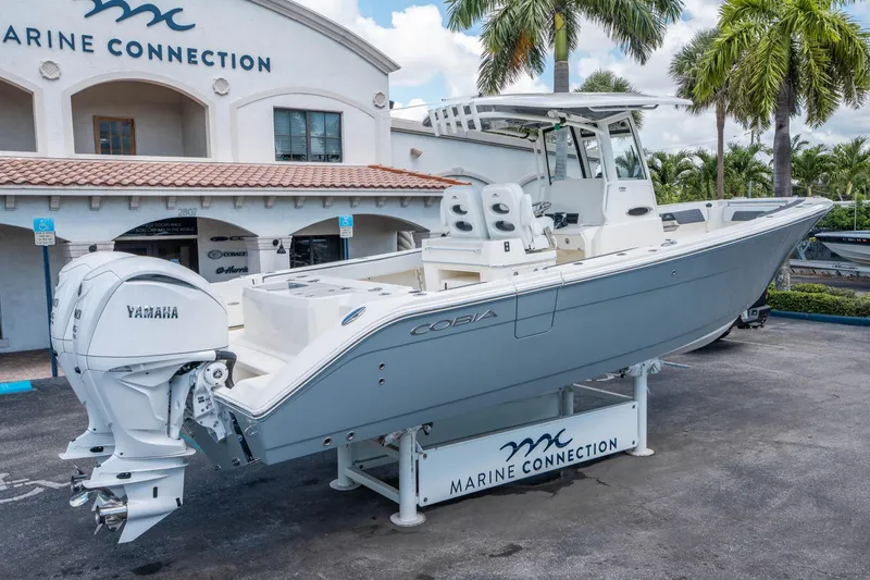 Slide: The Image of 2025 Cobia 285 CC boat with Yamaha engine at Marine Connection dealership. - 2