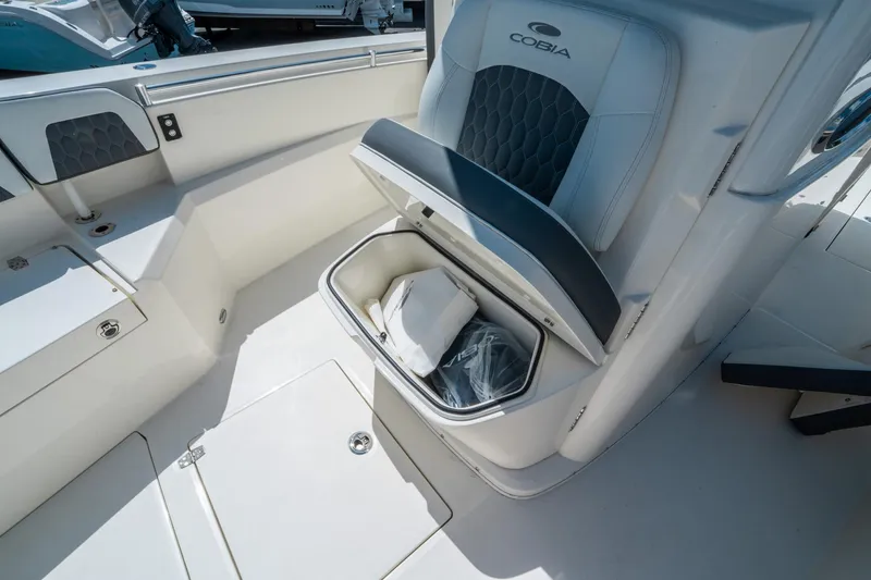 Slide: The Image of 2025 Cobia 285 CC boat interior with storage compartment under seat. - 34