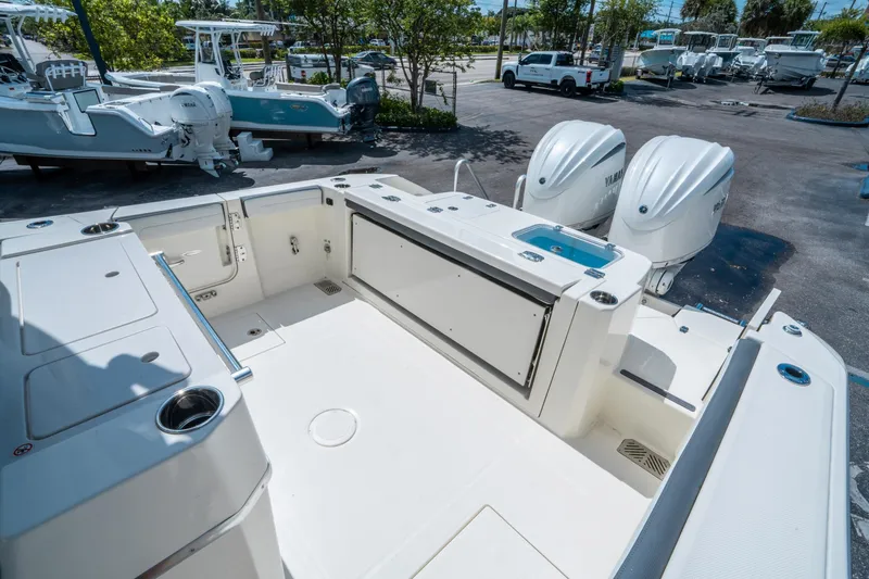 Slide: The Image of 2025 Cobia 285 CC boat with dual Yamaha engines, spacious deck, and modern features. - 12