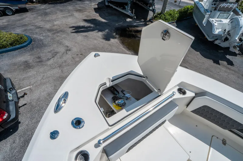Slide: The Image of 2025 Cobia 285 CC boat with open storage compartment on deck. - 35