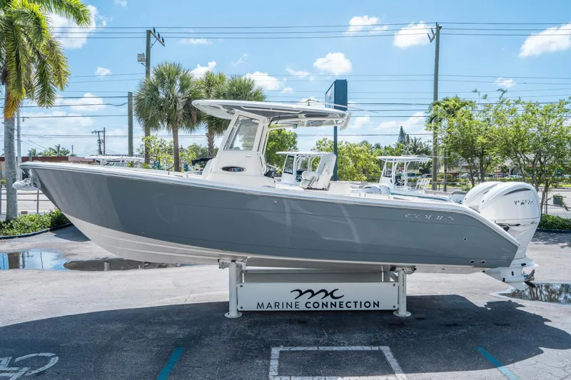 Slide: The Image of 2025 Cobia 285 CC boat displayed outdoors on a sunny day. - 5