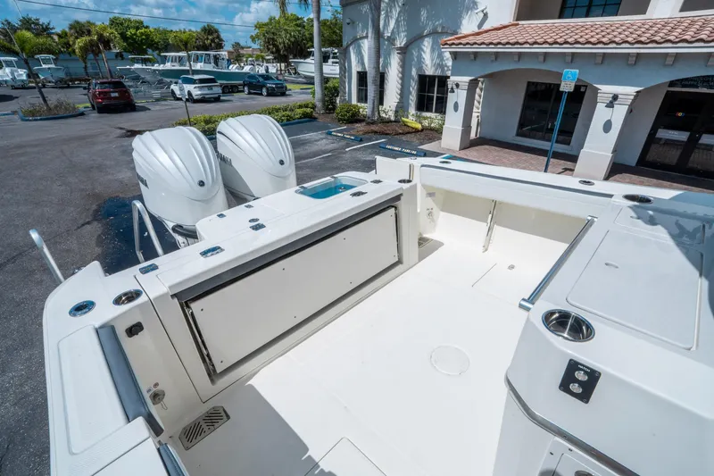 Slide: The Image of 2025 Cobia 285 CC boat with dual engines, spacious deck, and modern design. - 11